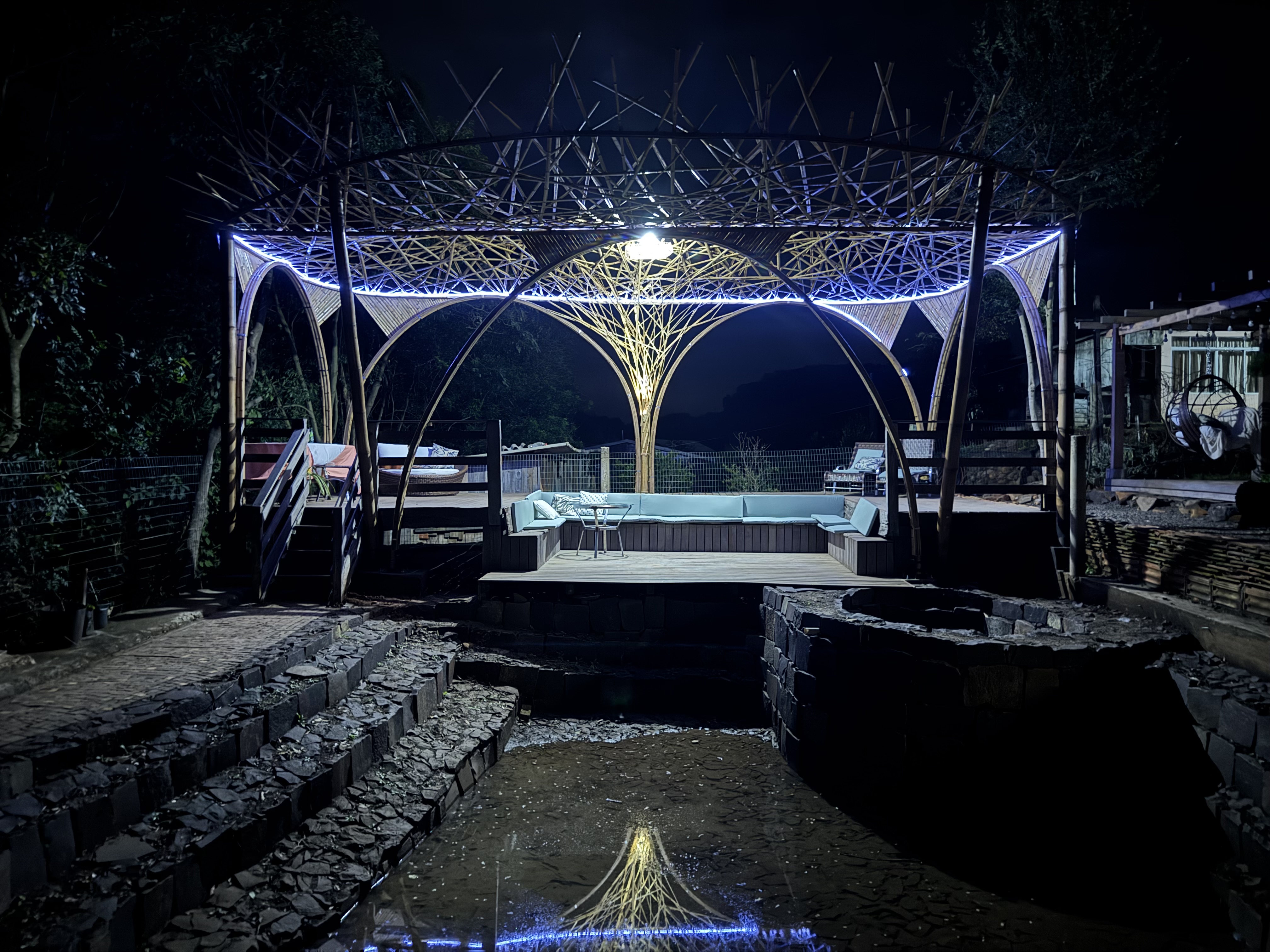 The completed bamboo pavilion illuminated at night